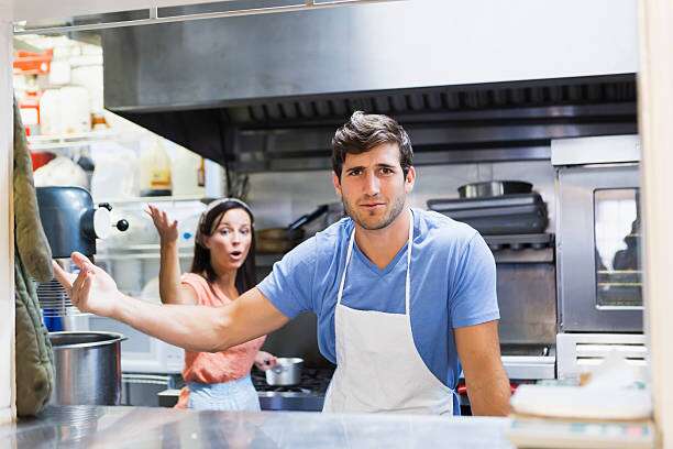A man and woman in a restaurant kitchen fighting | active shooter preparedness