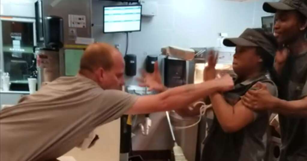 A man reaching over a fast food counter to assault the employees. Workplace Violence Prevention