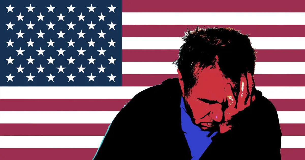 A man with his hands in his head in front of an American flag | Active shooter preparedness